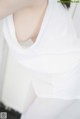 A close up of a woman wearing a white shirt.