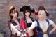 A group of three women dressed in pirate costumes posing for a picture.