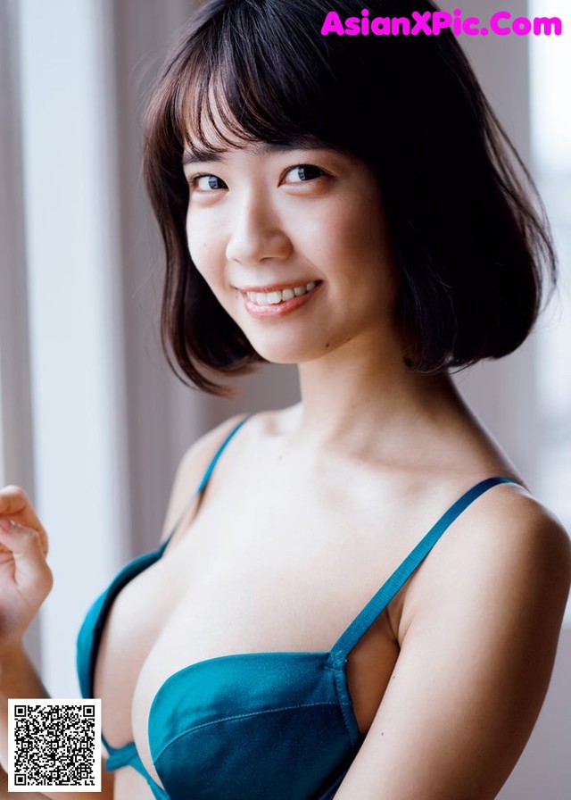 A woman in a blue bra posing for a picture.