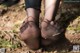 A pair of black sheer stockings on a woman's feet.