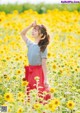 A woman standing in a field of sunflowers.