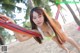 A woman in a bikini laying on a hammock on the beach.