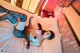 A woman laying on top of a bed in a room.